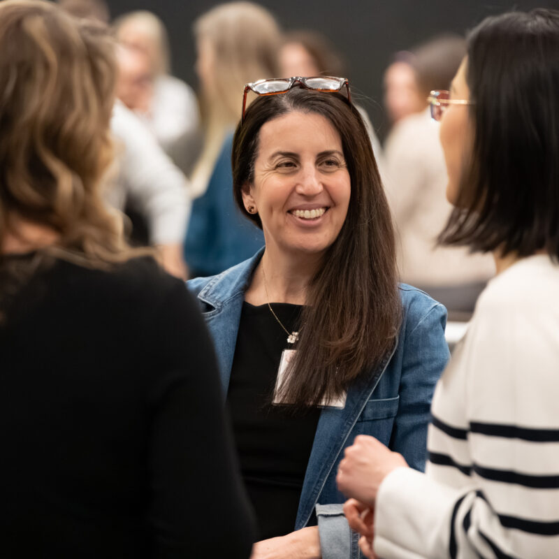colleagues share a laugh during the Kindsight Ascend kickoff