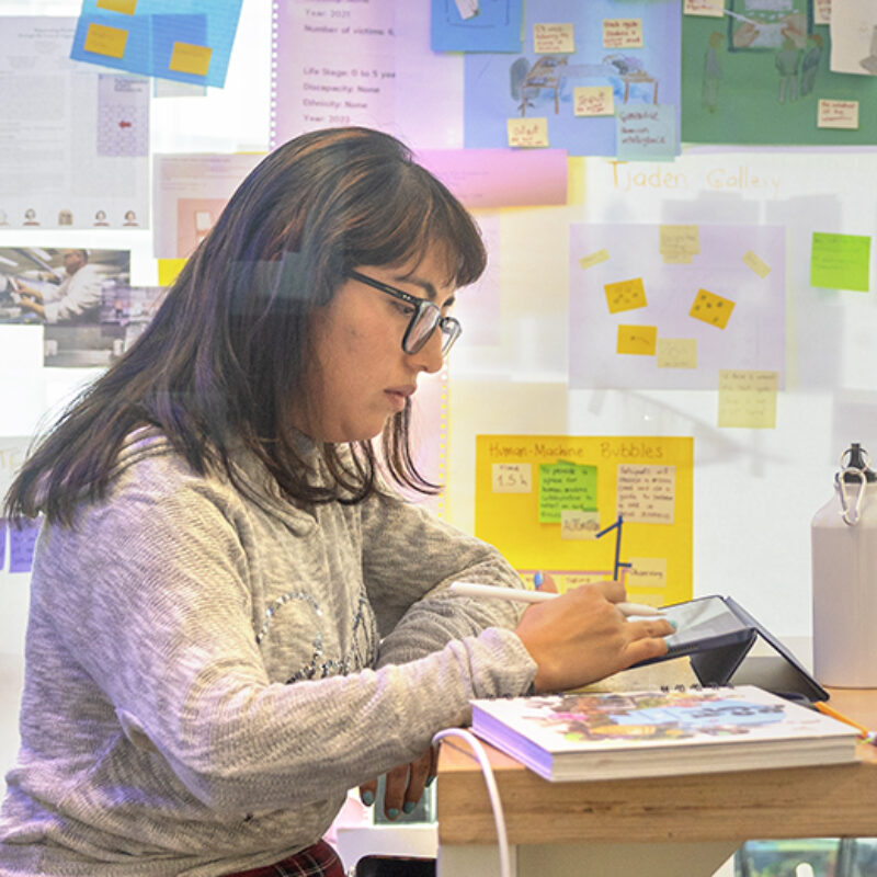 A CIS PhD student works in Gates Hall.