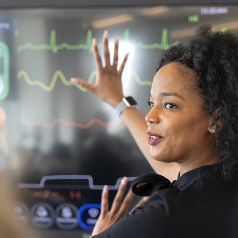 A Cornell Tech instructor explains biorhythms on a wall display