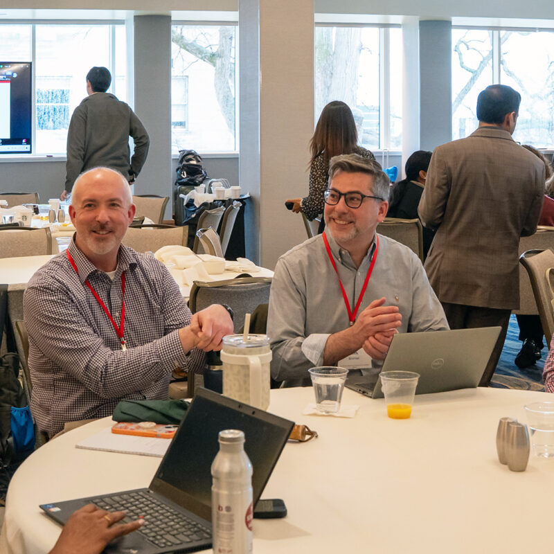 a group of colleagues chat during a workshop break