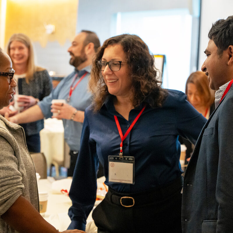a group of colleagues chat during a workshop break