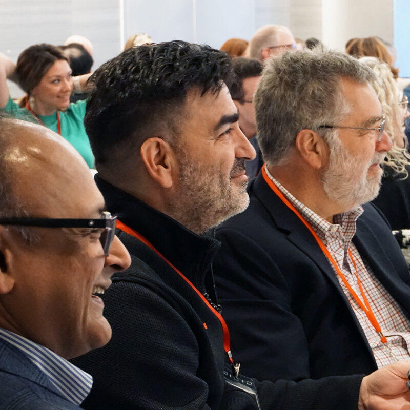 a group of colleagues enjoy a speaker's remarks during a workshop