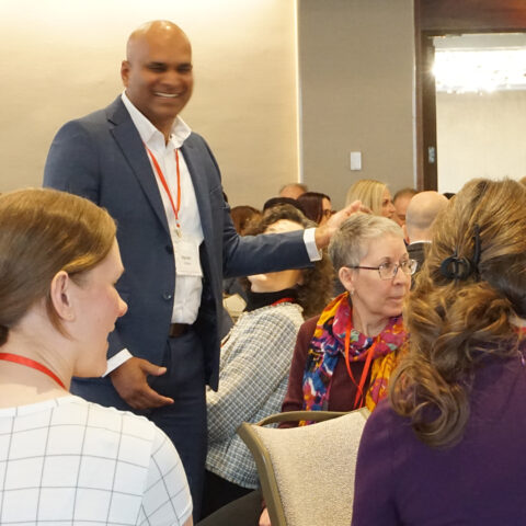 an audience member jokes with colleagues chat during a workshop discussion