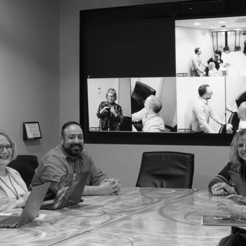 a group of colleagues in a hybrid meeting
