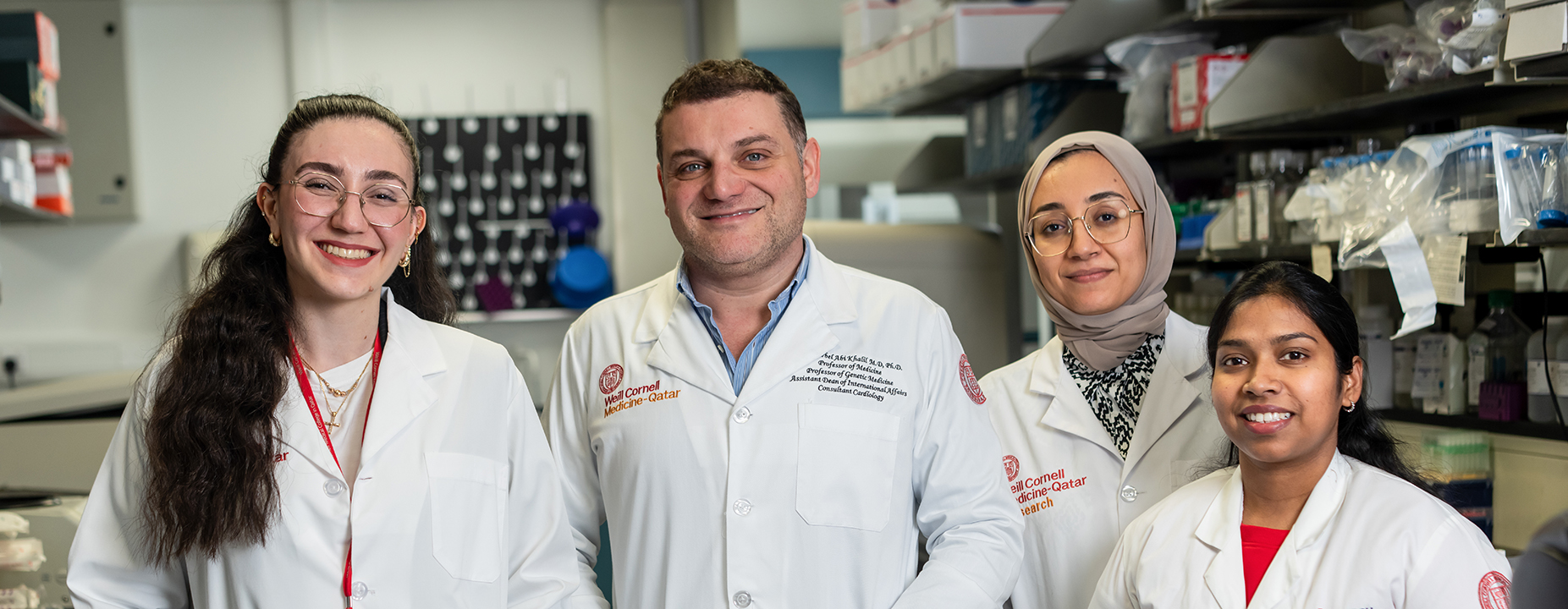 Four people smiling in a medical lab